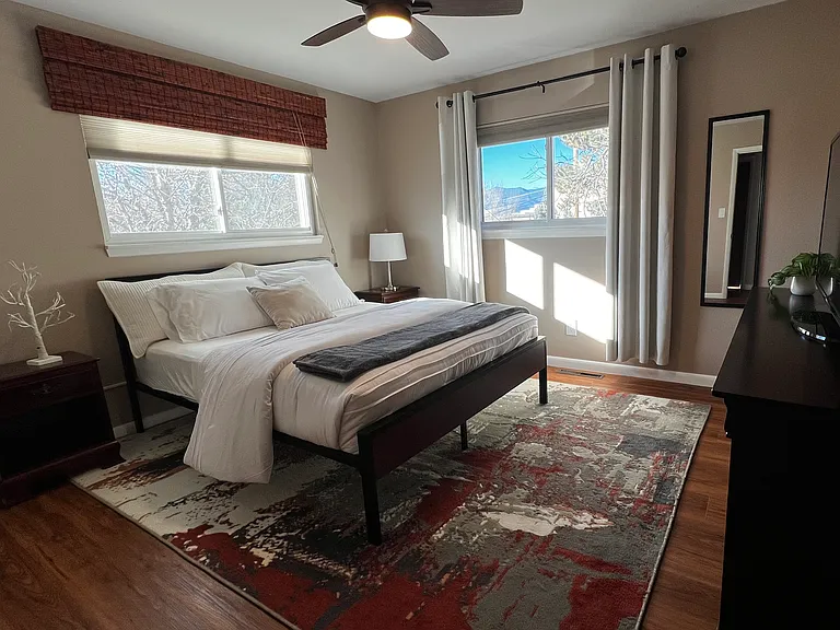 Primary bedroom with a comfortable queen bed and two spacious closets for extended-stay storage.
