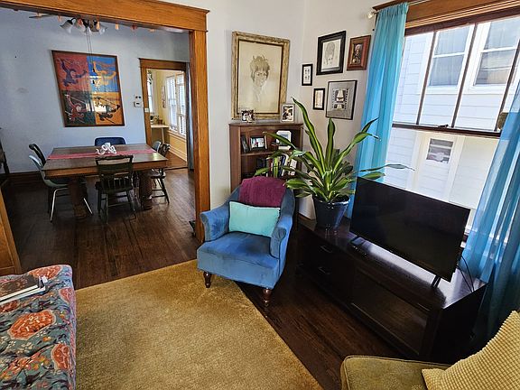 Living room just inside the front door. Thru to Dining room and kitchen. Furniture can stay or go inside as well.