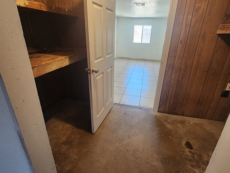laundry room is between bedroom 4 and the room that needs flooring. all is part of the converted carport
