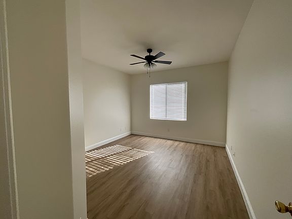 Downstairs bedroom with ceiling fan