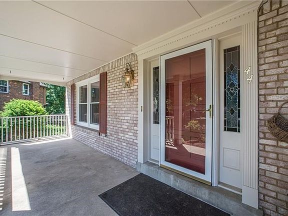 This front porch is the perfect spot to enjoy a nice summer afternoon.