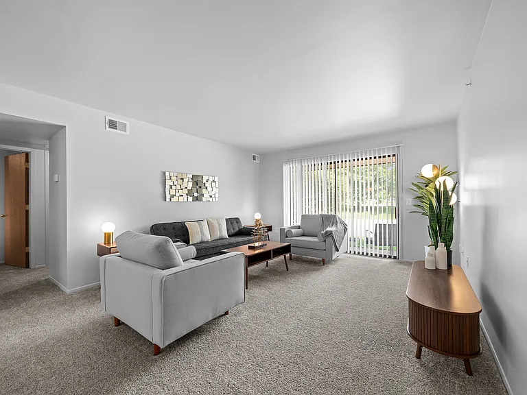 Living room with patio at Dover Hills Apartments in Kalamazoo