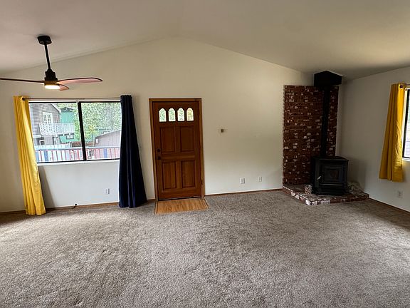 Large living room with a pellet stove and gas wall heater