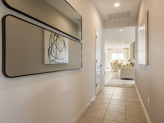 Enter the Verbena to a quint foyer that leads you to the secondary bedrooms and the main living area