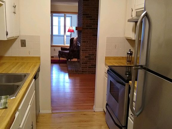 View from attached garage through kitchen, fireplace, and four-season porch.