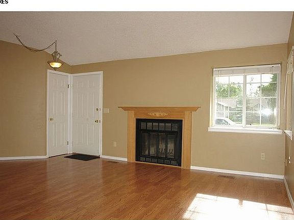 Bright, sunny living room with hardwood floors