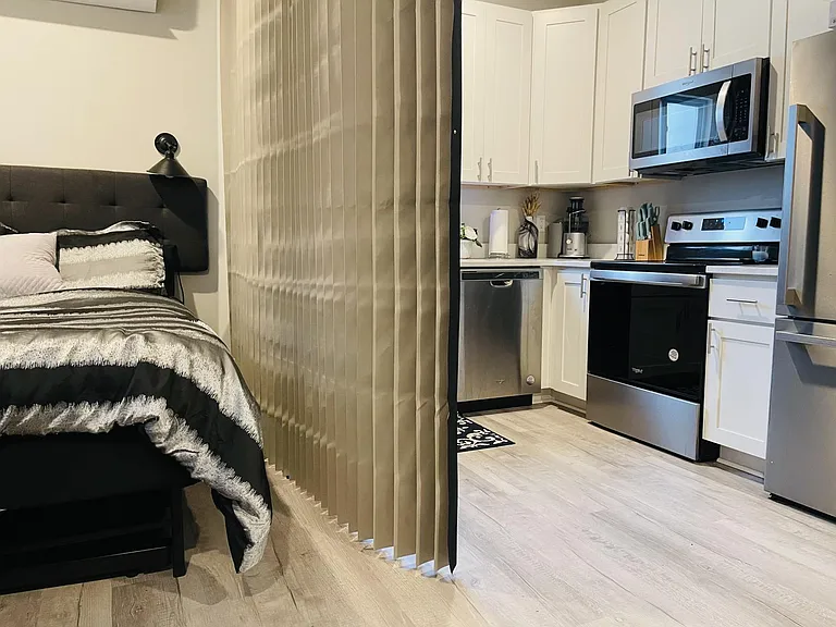 queen bedroom and kitchen with moveable divider