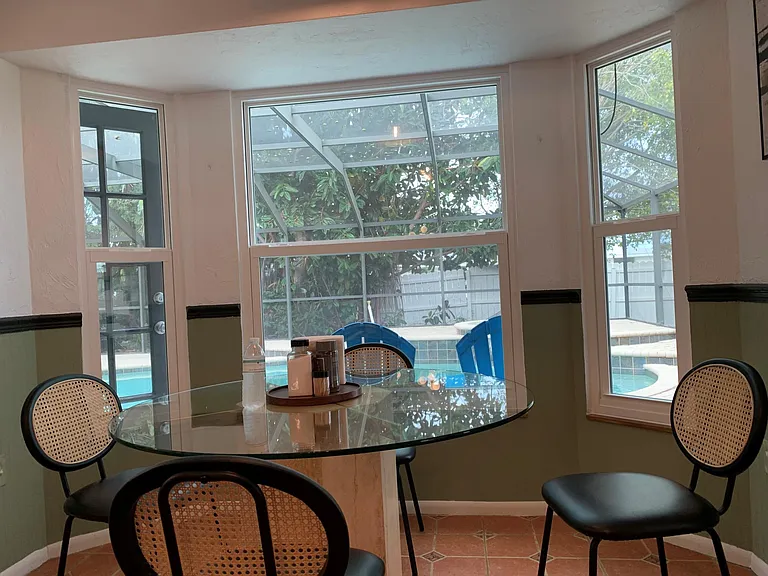 Breakfast area with pool and deck view.
