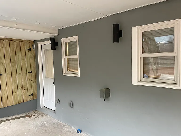Rear entrance of apartment leading to alley.