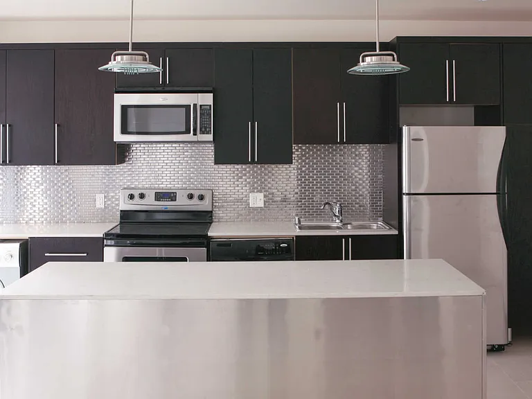 Kitchen with Stainless Steel Appliances and Tile Backsplash
