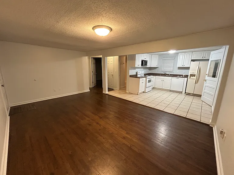 Kitchen includes frig, stove, and microwave.