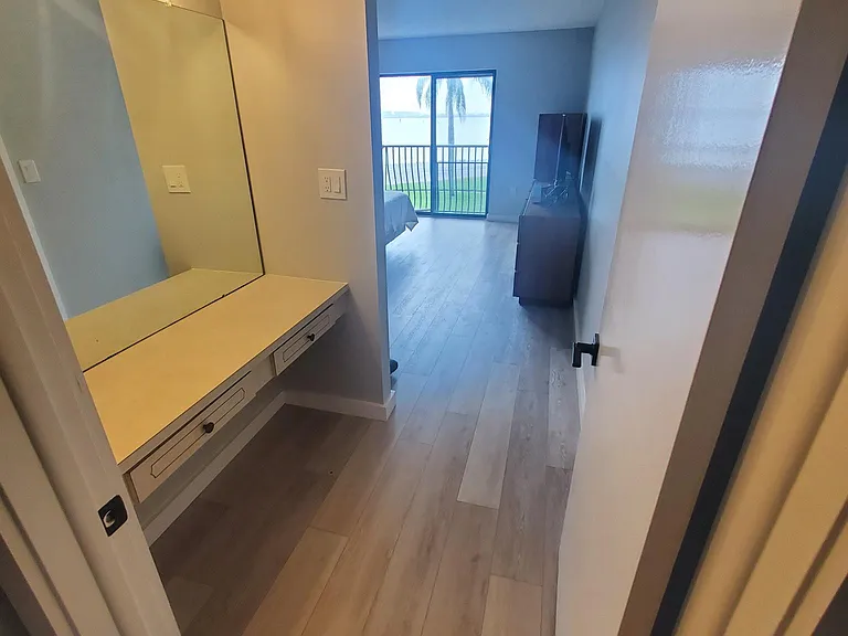 Vanity and walk in closet in Primary room with sliding doors to the private beach