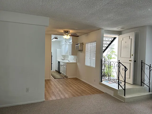View from the living room, the dining room and kitchen are bright includes all built in and other appliances. Tile countertops.