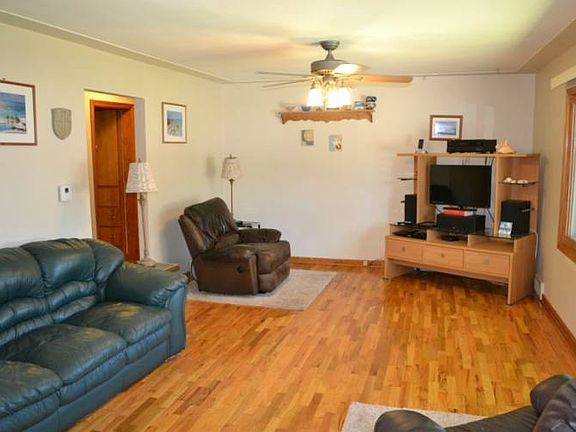 The Living room is a very generous size.  The recently refinished wood flooring and the picture window give it a warm inviting feeling.  The ceiling fan was added for those warm summer days. 