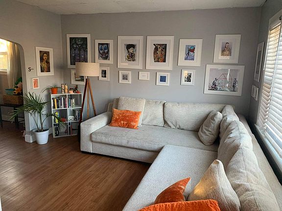 Living room with picture window also has door to front hallway and stairs to big upstairs bedroom with big closet and storage area.