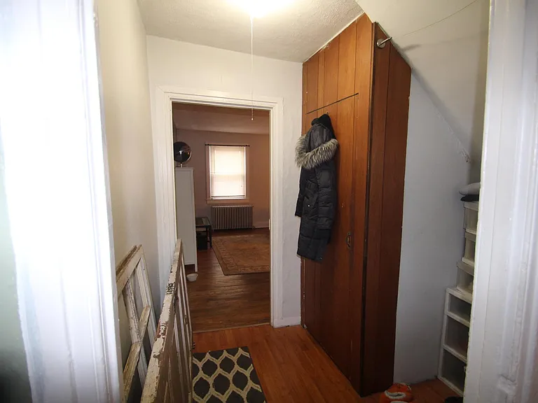 hallway between bedroom and kitchen (closet door on right)