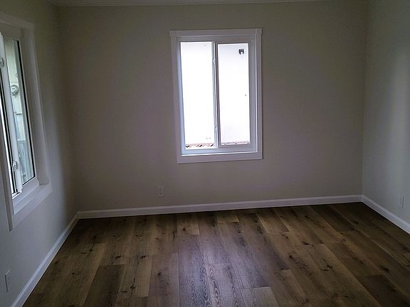Living room. New paint and floor, recessed lighting.