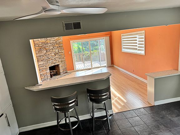 view from kitchen to living room and out to deck and beyond