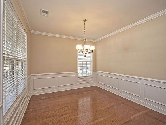 Dining room with crown molding, wainscoting, chair railing...
