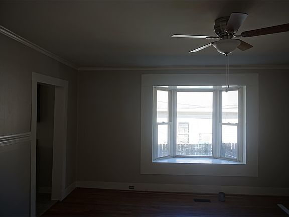Living room with large bay window. Ceiling fans throughout!