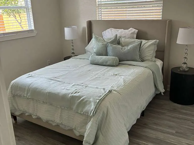 Warm, cozy bedroom with soft lamp lighting a relaxing end to every day.