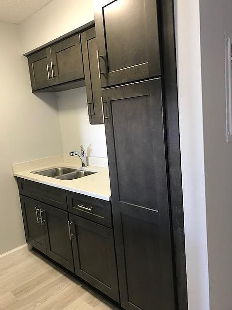 Brand new gray cabinets with white onyx countertops, new sink, new faucet, new floors, new paint! Very clean and modern!