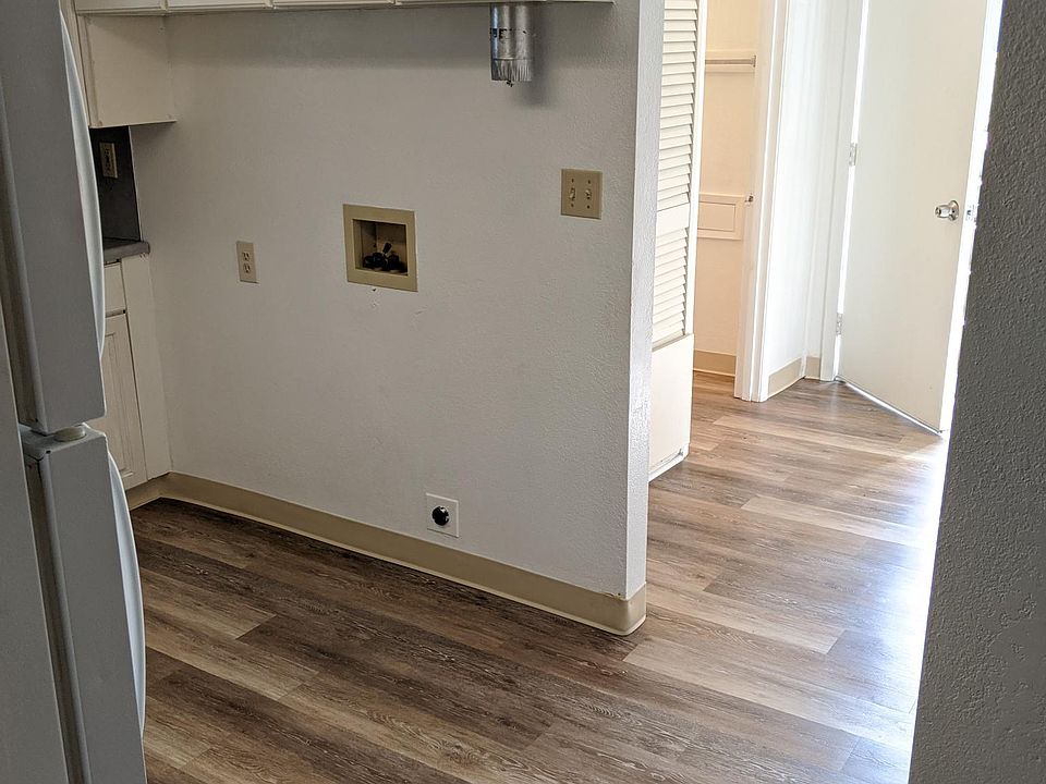 Kitchen with brand new floor showing washer/dryer hookups.