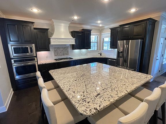 Chefs Kitchen with massive island with seating for 6