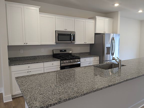 Kitchen with granite counter tops and stainless steel appliances
