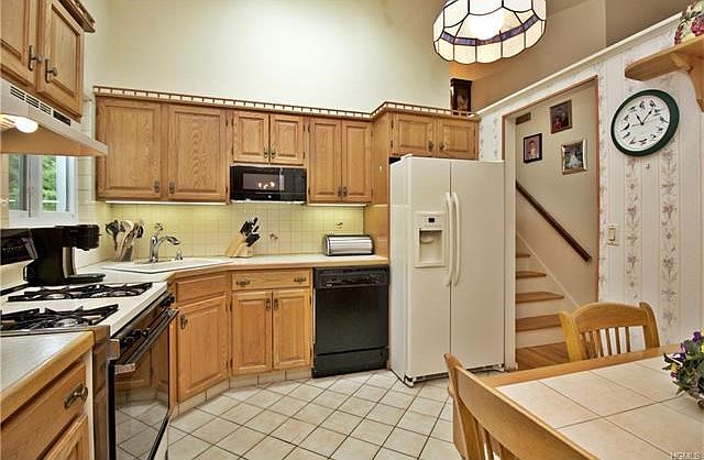Eat in kitchen with cathedral ceilings.  Generous cabinet and work space.
