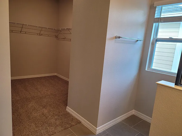 Deep large walk in closet in master bedroom