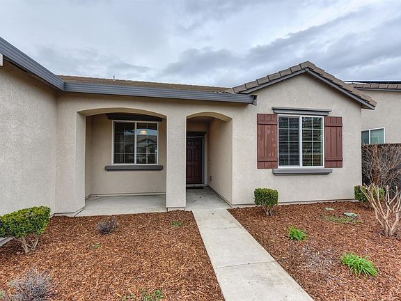 The inviting front walkway takes you to a darling front porch ready for your bench or swing.