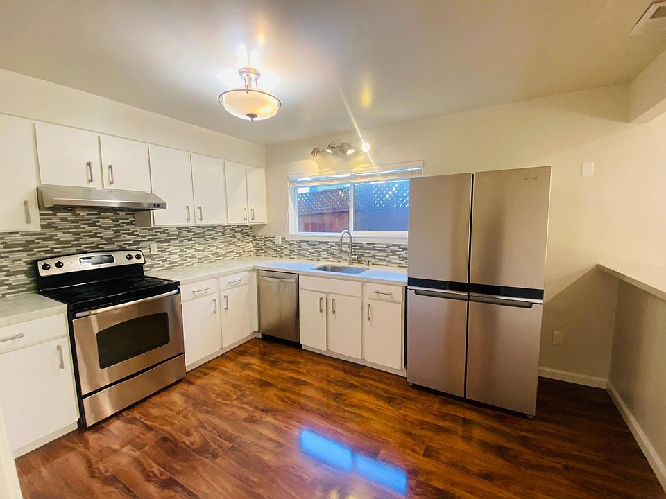 Kitchen including brand-new refrigerator.
