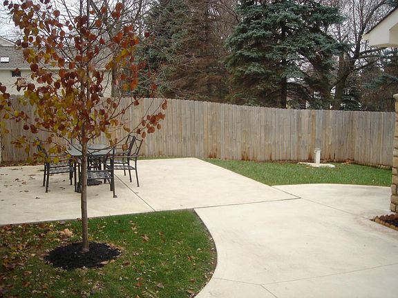 Private concrete patio and fenced yard.