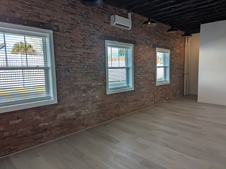 Living area with exposed brick wall