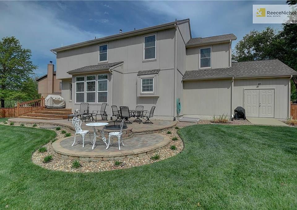 Beautiful stone patio with built in fire pit with a terraced deck