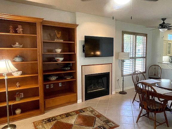 Electric controlled fireplace allows you to turn on warm cozy fires on cold rainy days with the flip of a switch. The custom cabinets hold all your books and TV equipment. 55 inch TV above the fireplace.