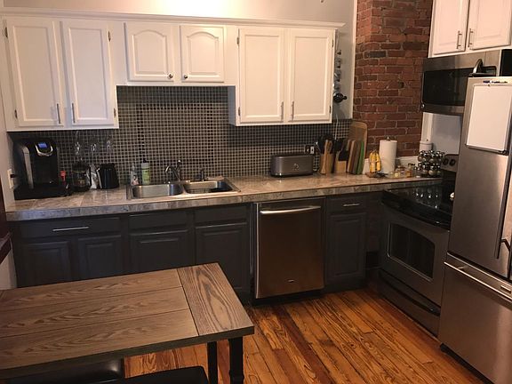 Kitchen complete with marble countertops and dishwasher