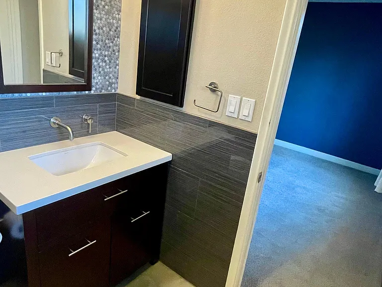 exquisite tile work in the master en suite with wall mount Fossett and recessed outlet