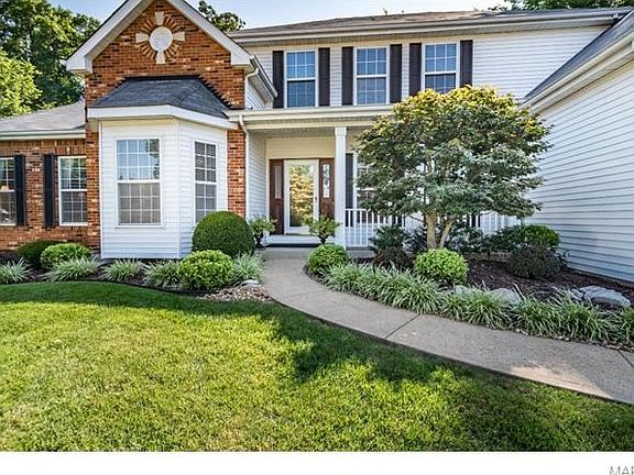 Covered porch and beautiful gardens have desirable appeal