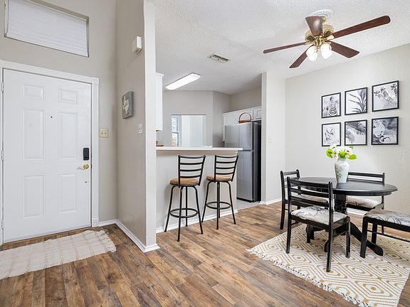 Cozy dining area with a round table for 4, plus additional seating for 2 at the kitchen island_perfect for meals, coffee, or conversation.