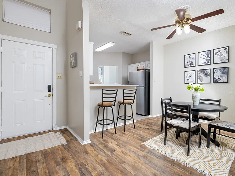 Cozy dining area with a round table for 4, plus additional seating for 2 at the kitchen island_perfect for meals, coffee, or conversation.
