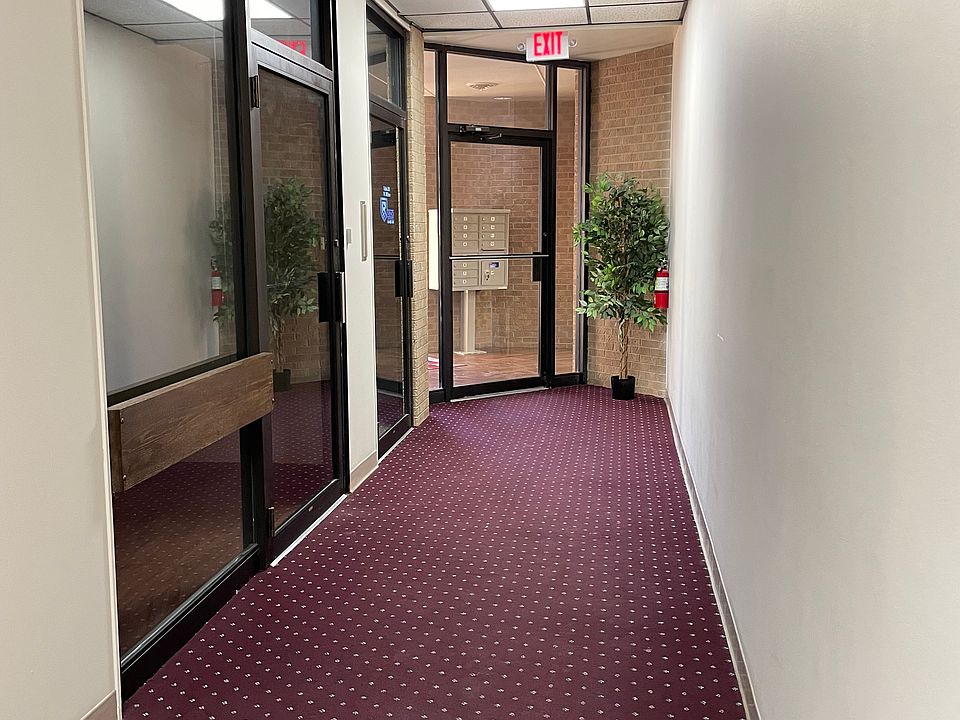 Side of view of office suite to exterior doors and mailbox