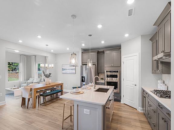 The bright and resourceful kitchen features ample space for meal prepping and storage.