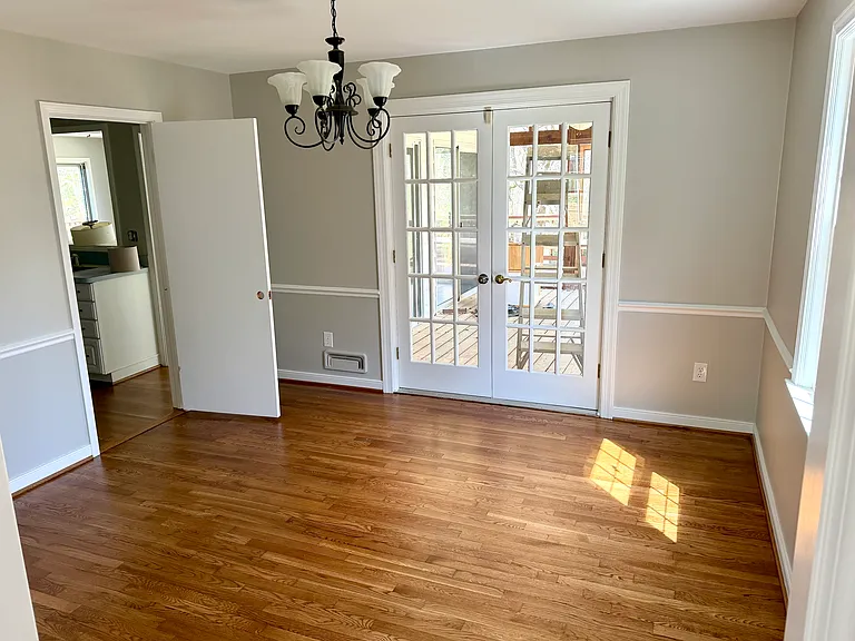 Formal dining room with french doors to a screened porch.
