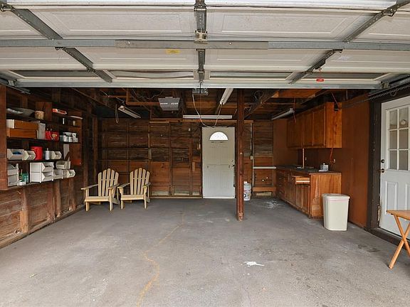 Garage with cabinet storage.
