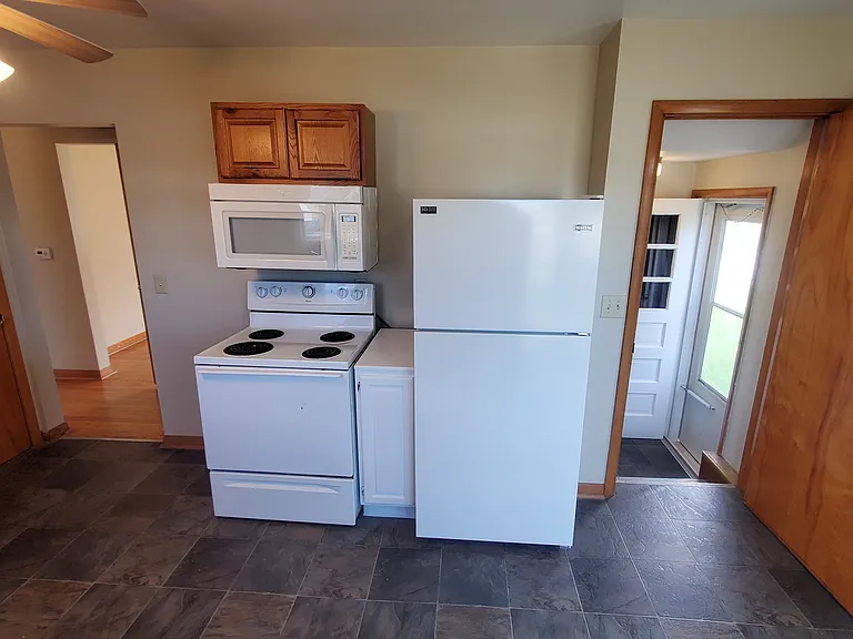 Kitchen - Main level. Side Entry door on right side of photo. Basement stairs straight in from entry door.