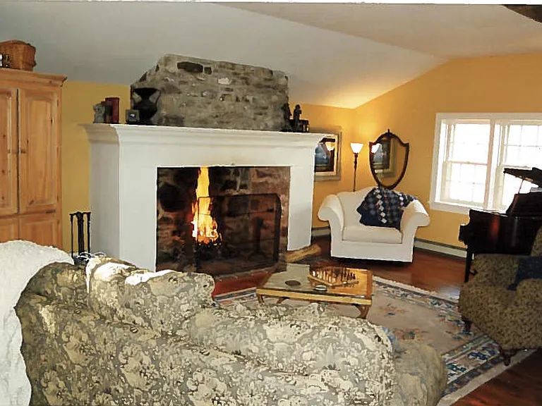Step down living room off kitchen, with historic fireplace (non-working), wide-plank flooring