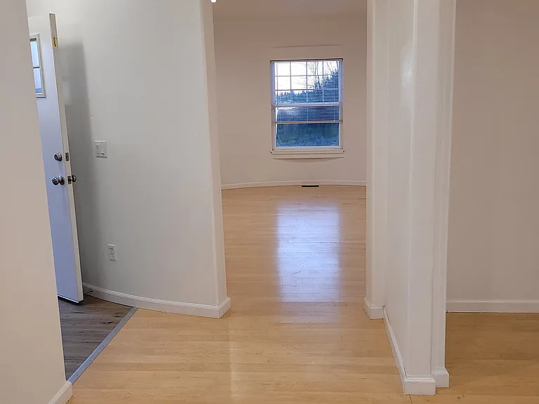 main entrance door (left) leading into the living room (directly ahead) or formal dining (right).