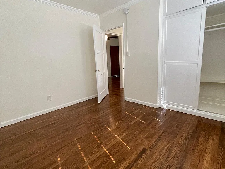 Bedroom featuring hardwood floors and generous closet